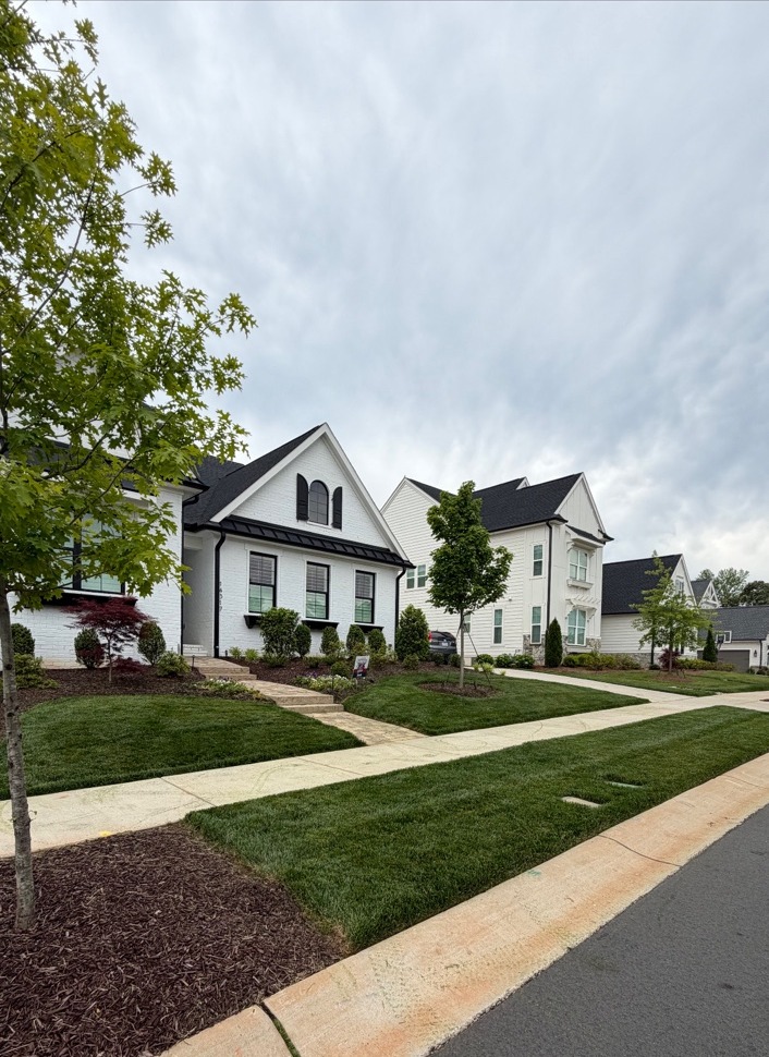 Clean front lawn in a neighborhood with landscaping beds